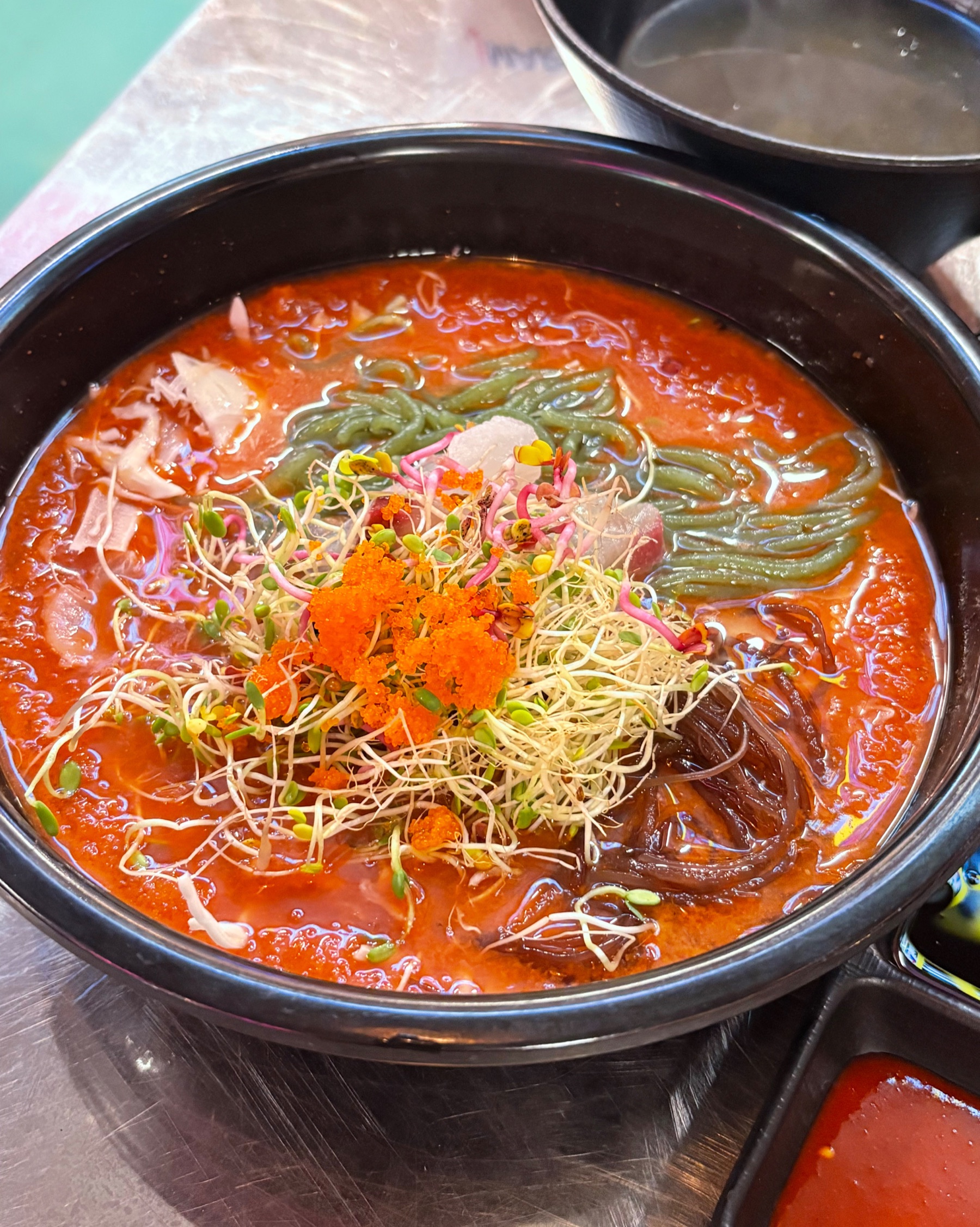 뚝배기에 담긴 해물물회, 날치알과 새싹 고명